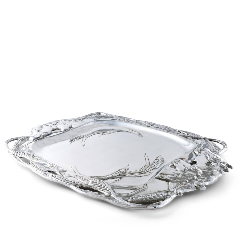 Decorative silver tray with intricate designs on a white background