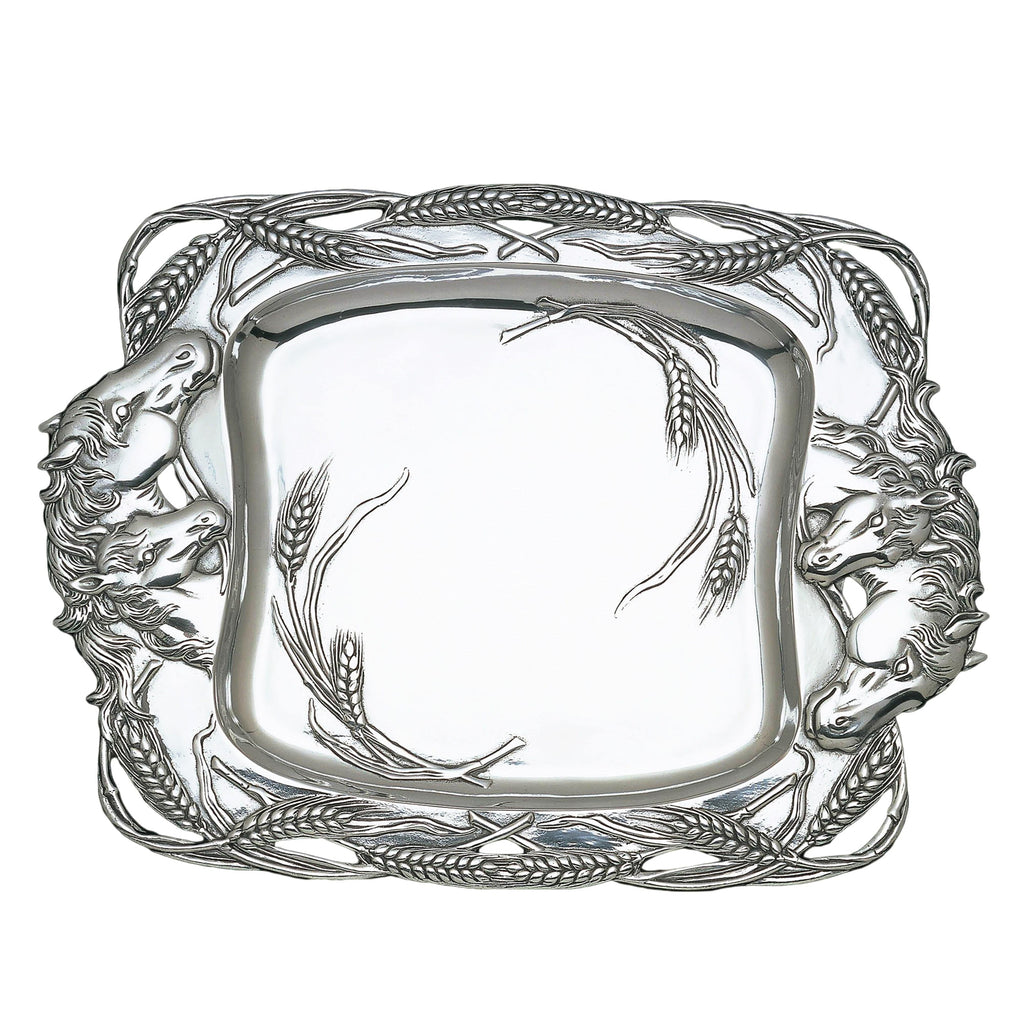 Silver belt buckle with horse and wheat design on a white background