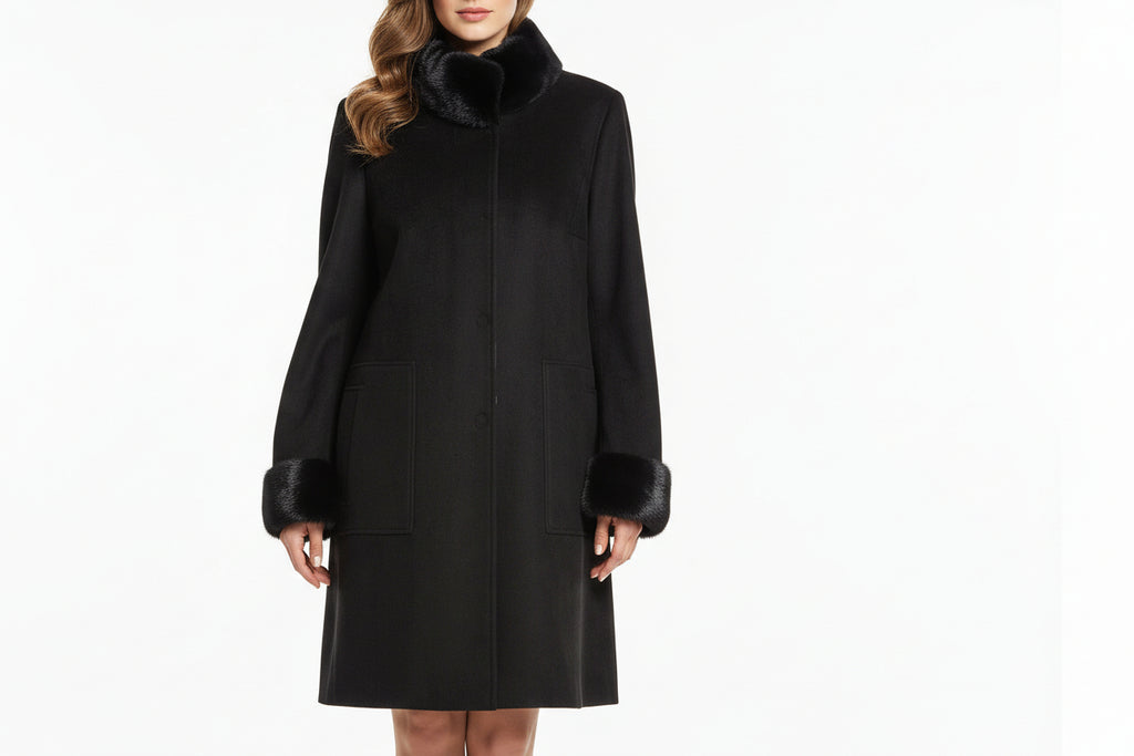 Black cashmere coat with mink fur trim on a mannequin against a neutral background