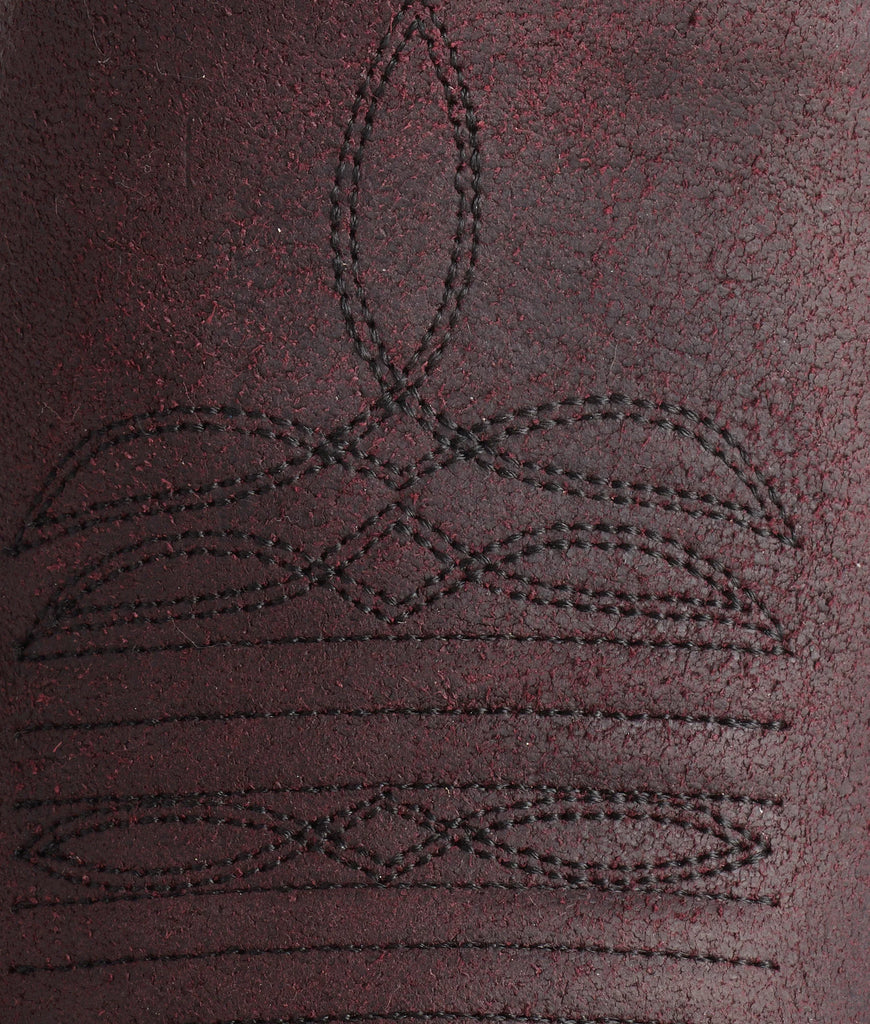 Close-up of a textured brown surface with black stitching patterns