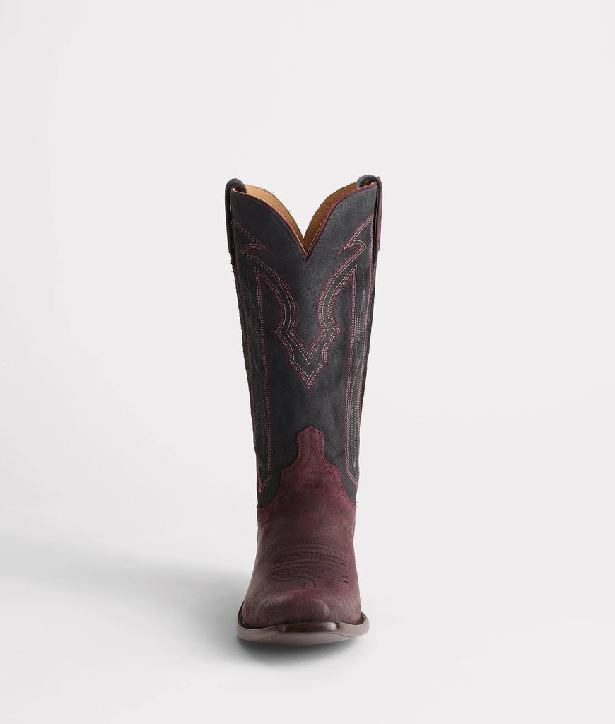 Brown cowboy boot with black sole on a white background