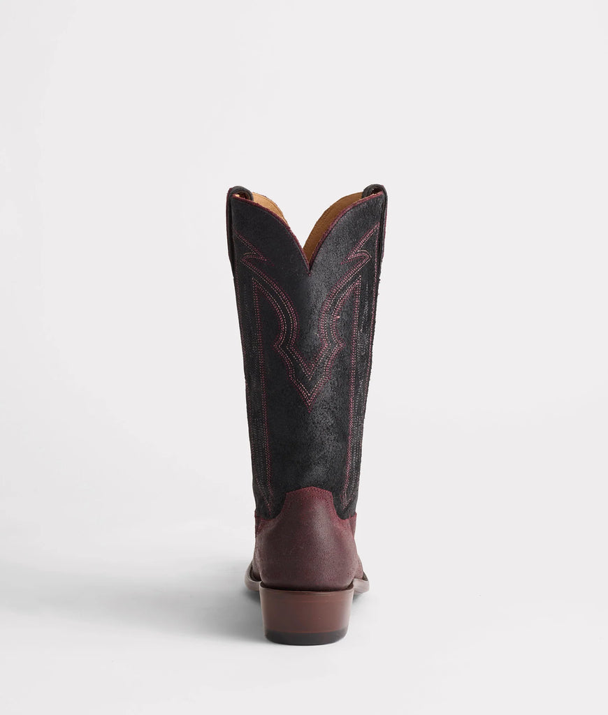 Brown and black cowboy boot on a white background