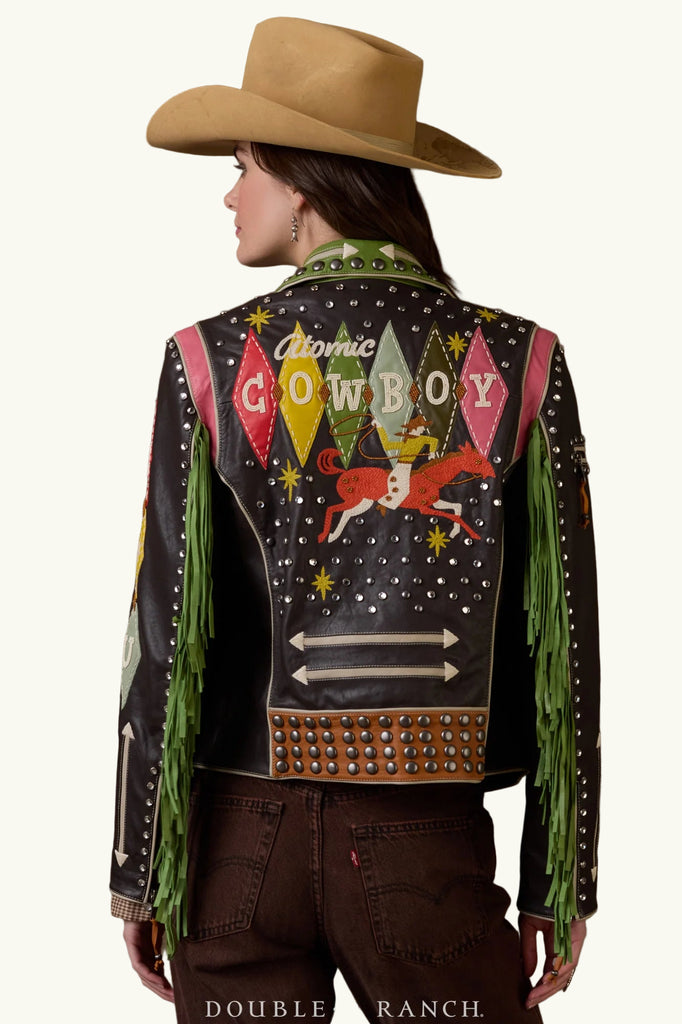 Person wearing a decorated cowboy jacket with 'Atomic Cowboy' design on a brown background