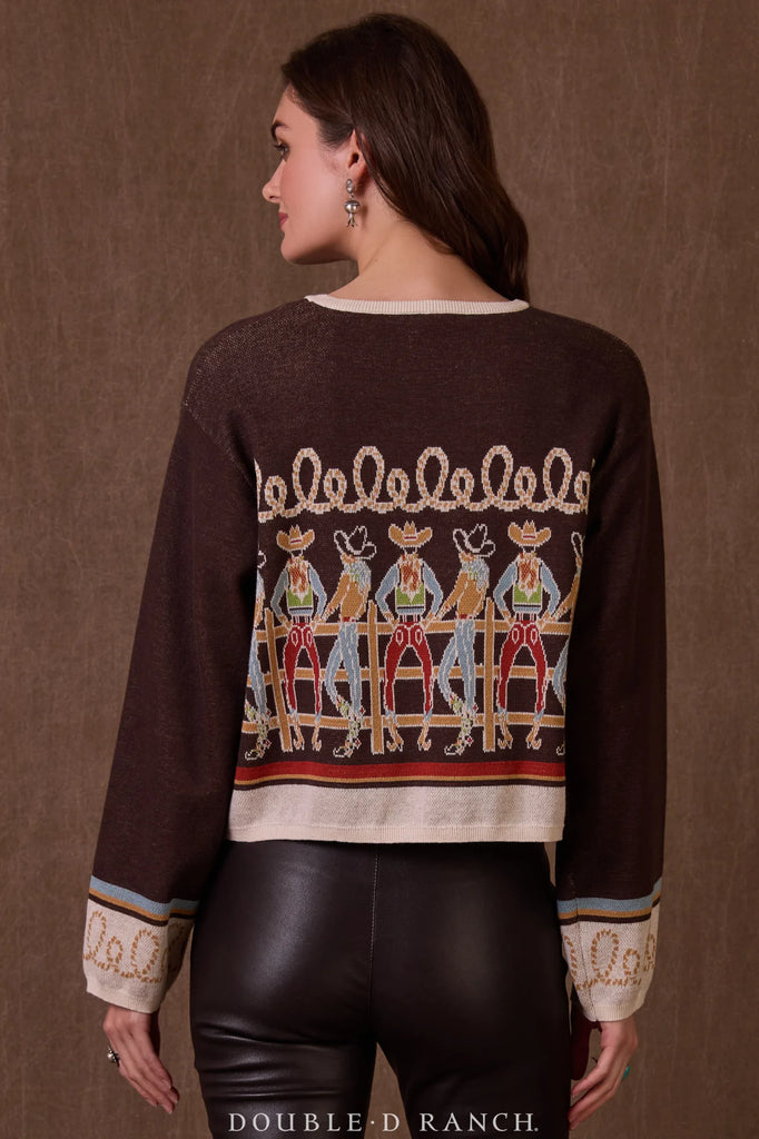 Woman wearing a brown sweater with embroidered design on a brown background