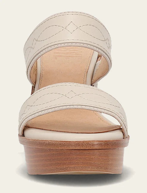A single platform wedge sandal in cream and tan, featuring two wide decorative straps with stitched diamond patterns and a stacked wood-look platform heel, shown against a light cream background.