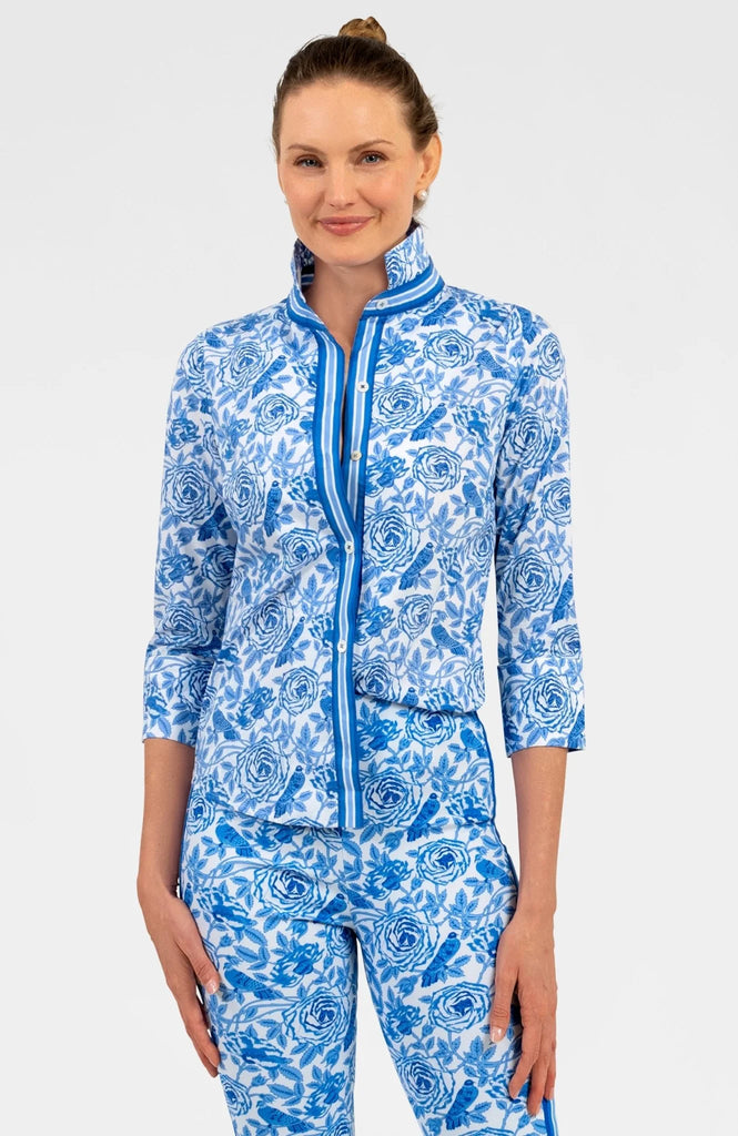 Woman wearing a blue and white patterned outfit on a white background