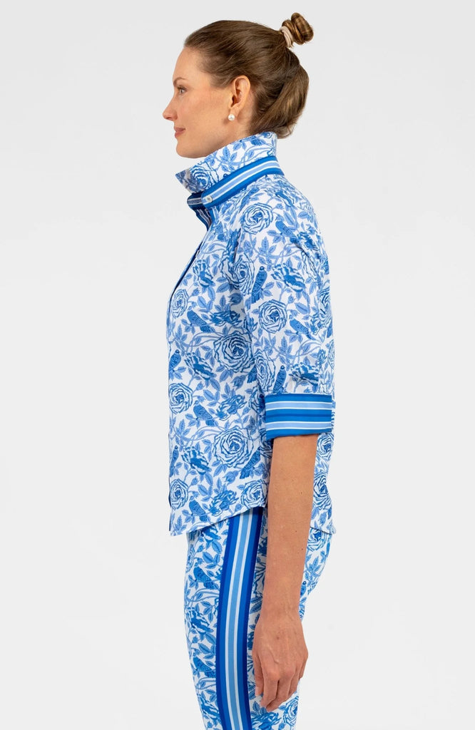 Woman wearing a blue and white patterned outfit on a white background