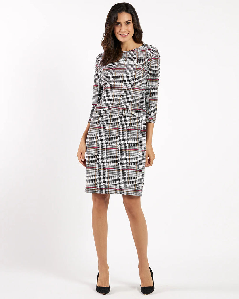 Woman wearing a checkered dress on a white background