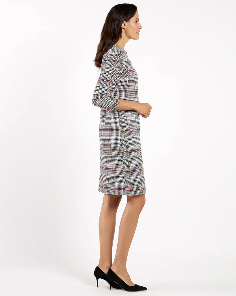Woman wearing a plaid dress on a white background