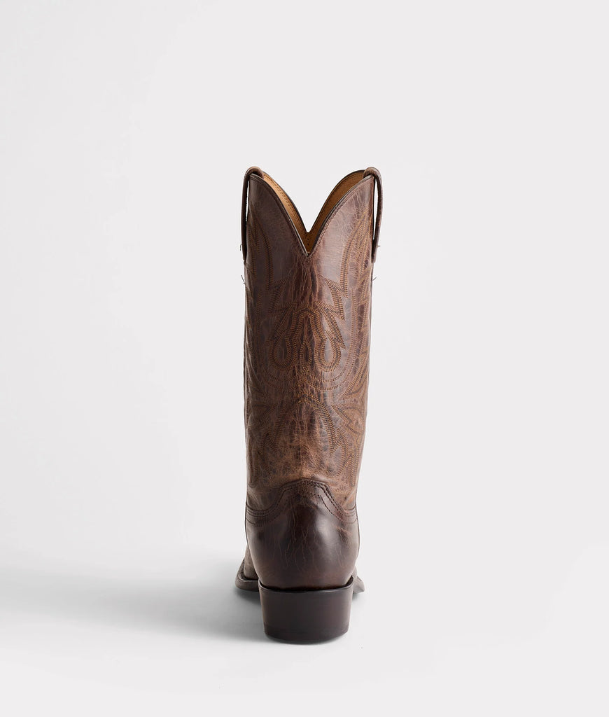 Brown cowboy boot on a white background