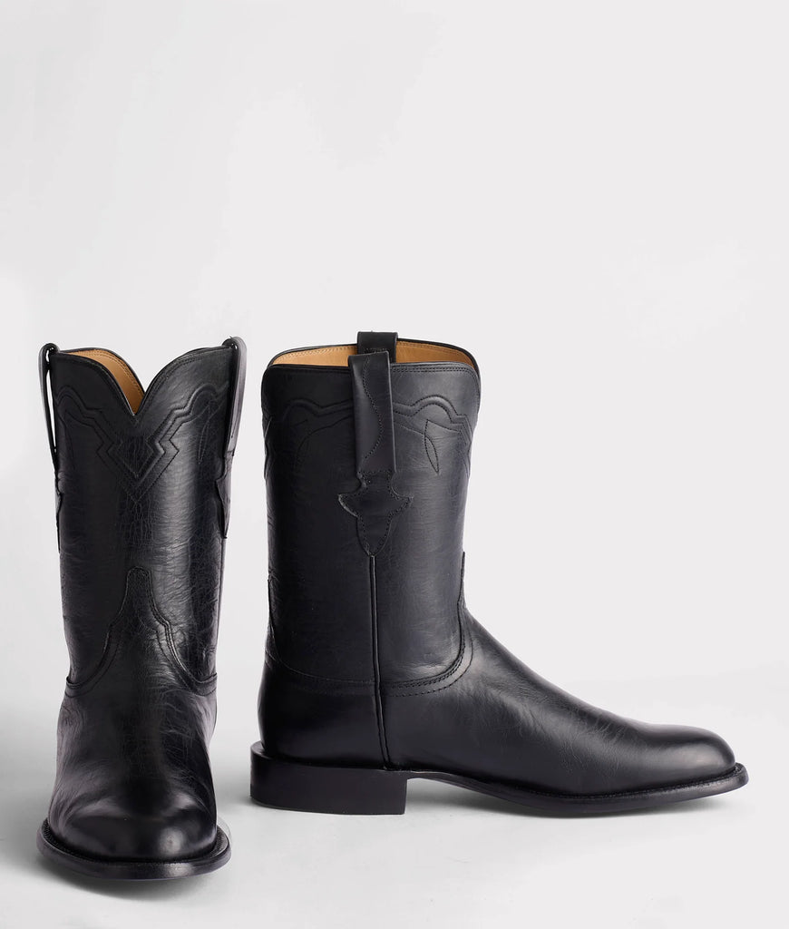 Pair of black leather boots on a white background