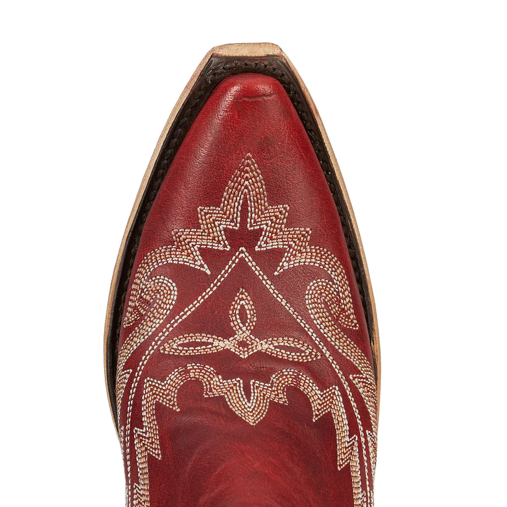 Close-up of a red cowboy boot with intricate white embroidery on a white background