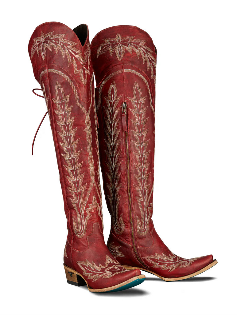 Red cowboy boots with white embroidery on a white background