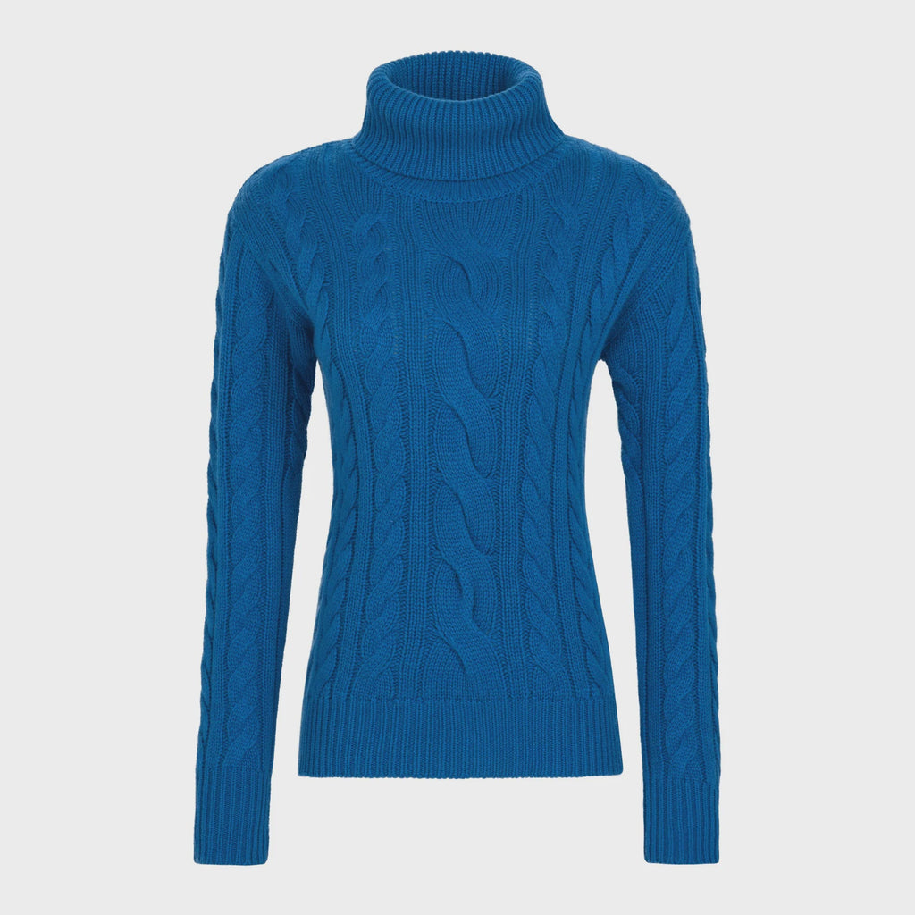 Blue cable knit turtleneck sweater on a light gray background