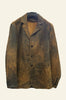 Brown leather jacket on a mannequin in a store setting with bags and folded clothes in the background.