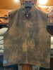 Brown leather vest on a hanger with a wooden background