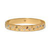 Gold bracelet with embedded crystals on a white background