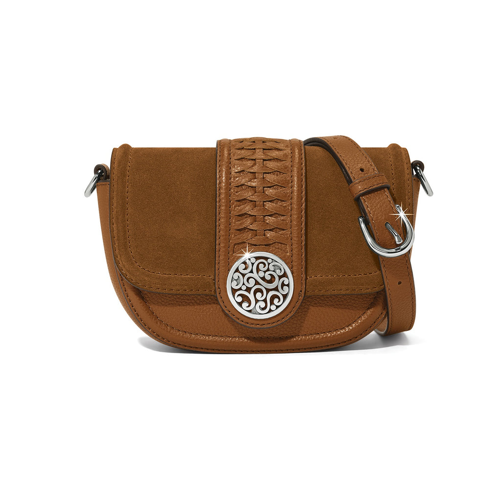 Brown leather handbag with decorative emblem on a white background
