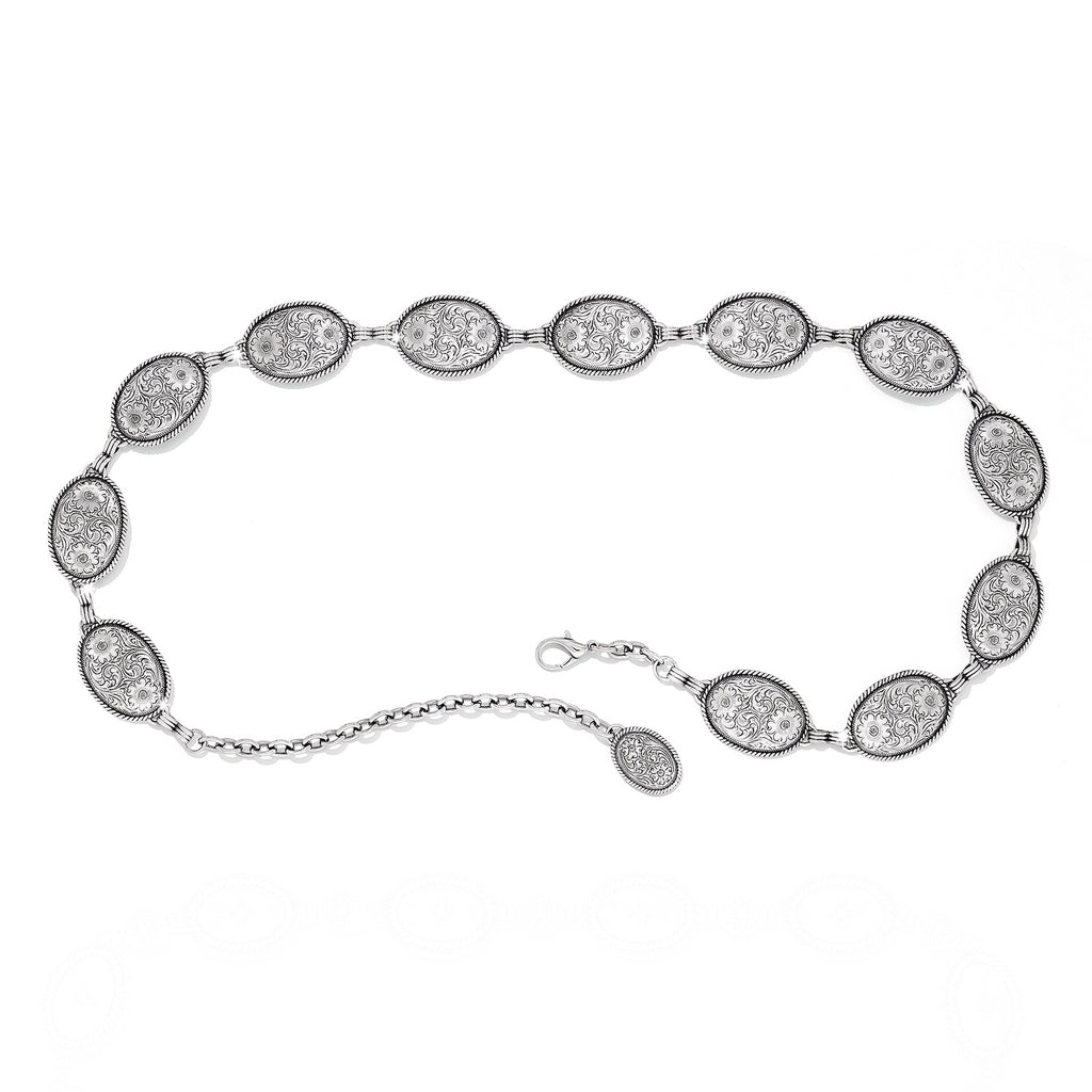 Silver bracelet with oval-shaped diamond-like stones on a white background