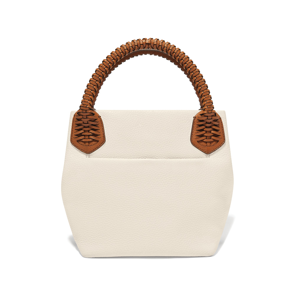 White handbag with brown woven handles on a white background