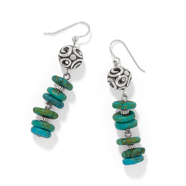 Pair of turquoise beaded earrings with silver hooks on a white background