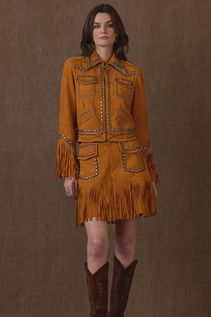 Woman wearing a mustard yellow fringe outfit with a brown background, featuring 'Double D Ranch' branding.
