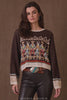 Woman wearing a patterned sweater with a brown background