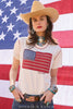 Woman wearing a t-shirt with an American flag design in front of an American flag background.