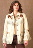 Woman wearing a cream-colored western-style jacket with fringe and embroidery on a brown background