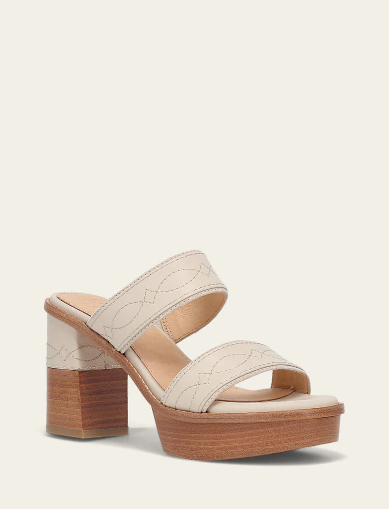 Beige sandal with wooden block heel on a light beige background