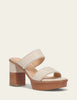 Beige sandal with wooden block heel on a light beige background