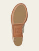 Close-up of a shoe sole with 'Frye' branding on a beige background