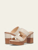 Beige platform sandals with wooden block heel on a light beige background