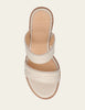 A single cream-colored leather slide sandal with decorative stitching on the straps, shown from a top-down view against a light beige background.