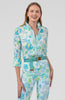 Woman wearing a floral patterned outfit on a plain background