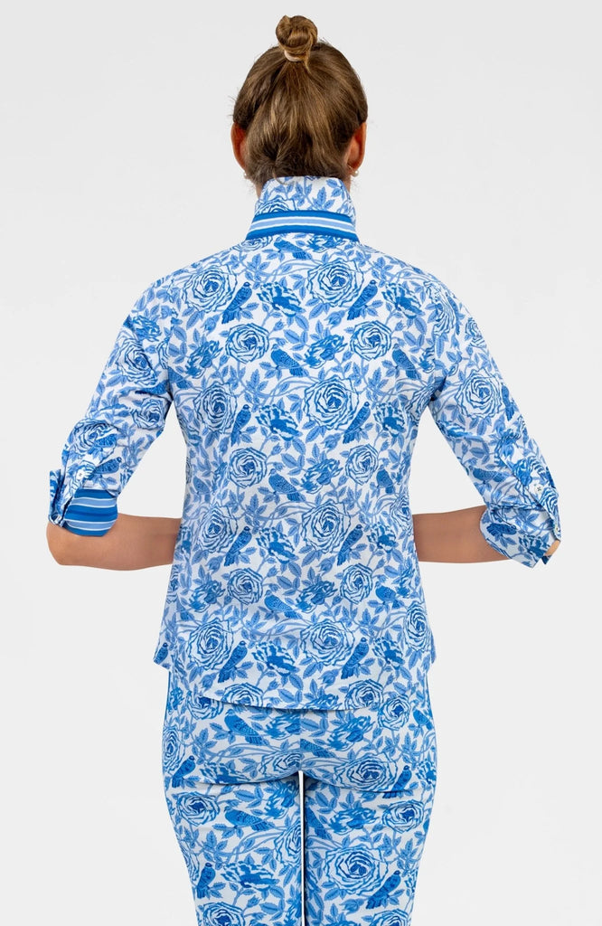 Person wearing a blue and white patterned outfit on a plain background