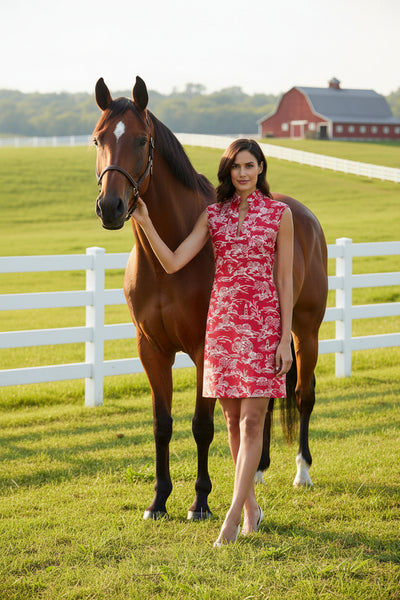 Woman wearing a red patterned dress on a white background