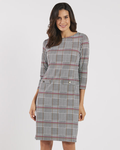 Woman wearing a checkered dress on a white background