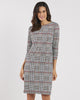 Woman wearing a checkered dress on a white background