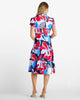 Woman wearing a colorful patterned dress on a white background