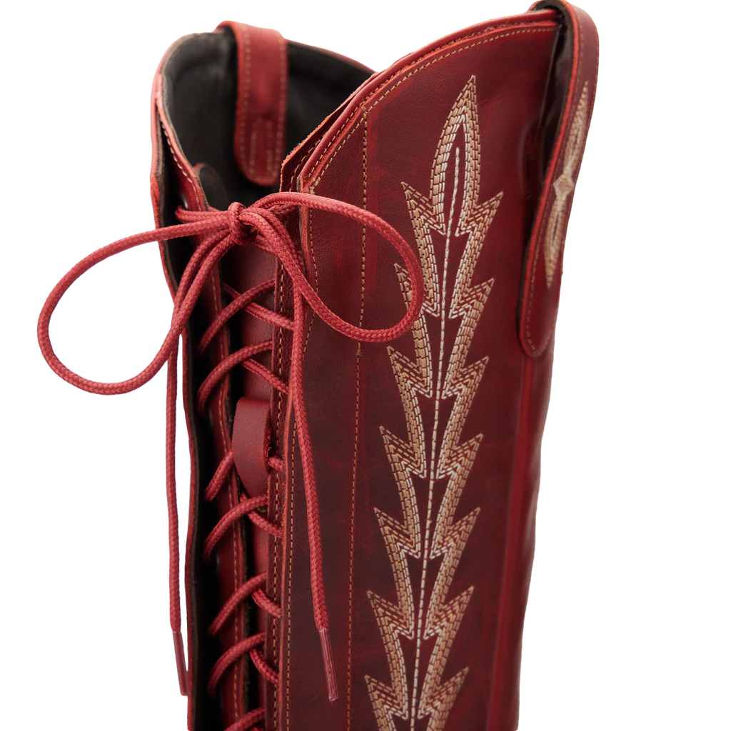 Red boot with intricate gold embroidery on a white background