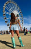Person wearing turquoise cowboy boots with a Ferris wheel in the background