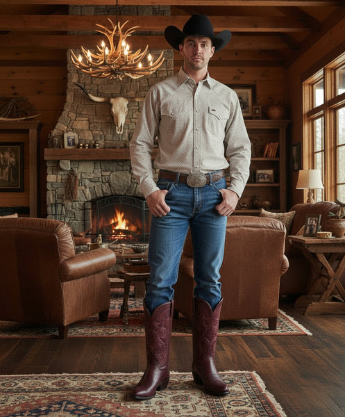 Pair of burgundy leather Lucchese cowboy boots on a light gray background