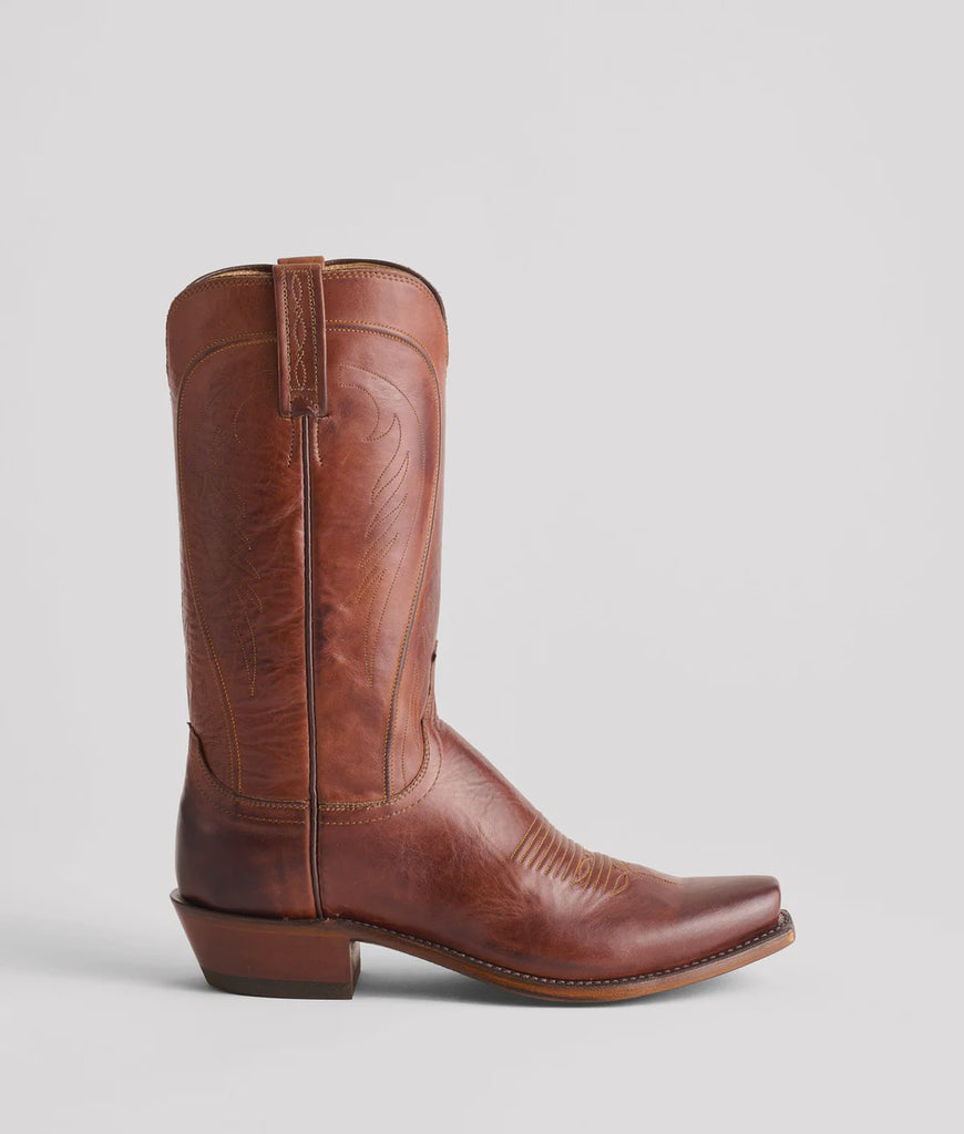 Brown leather cowboy boot on a light gray background
