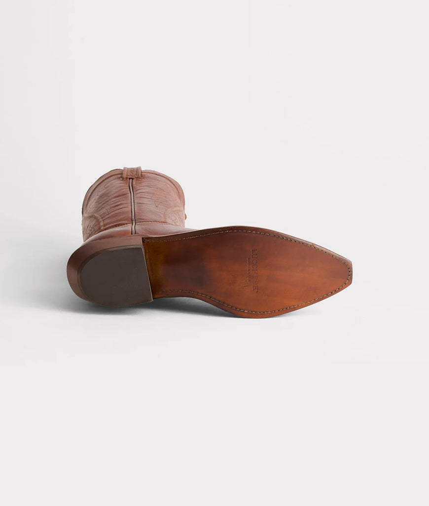Brown leather boot sole on a light gray background