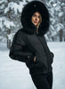Black puffer ski jacket with fur hood on a mannequin in a store setting