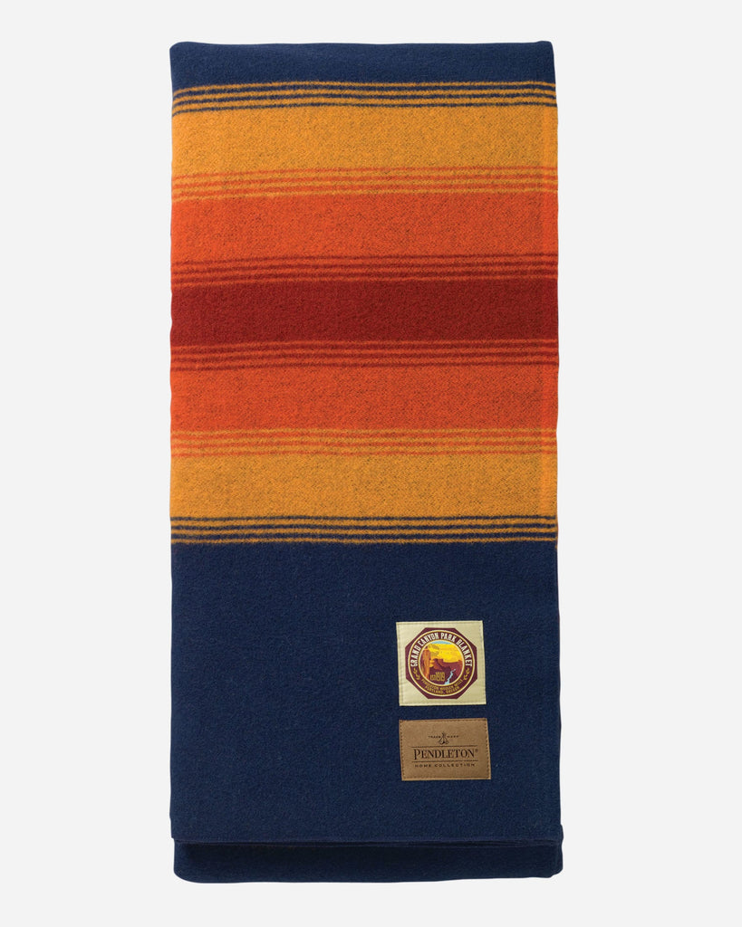 Colorful striped blanket with a brand logo on a white background
