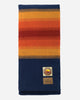 Colorful striped blanket with a brand logo on a white background