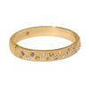 Gold bracelet with embedded colorful gemstones on a white background