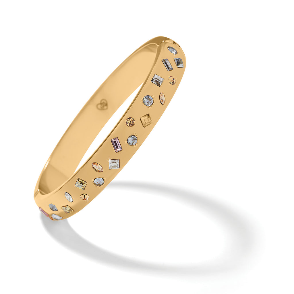 Gold bracelet with embedded gemstones on a white background